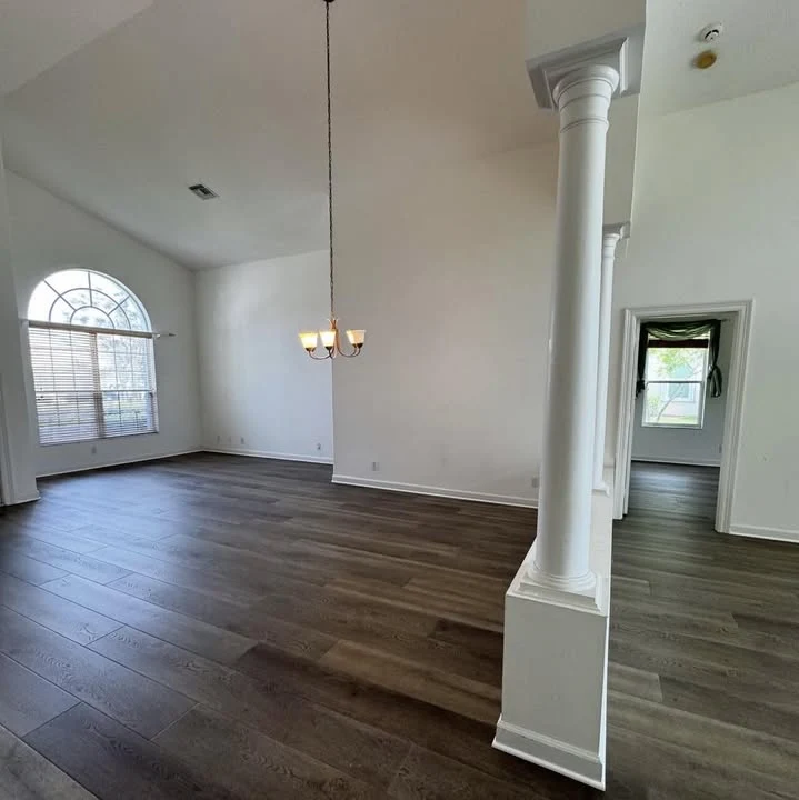 FlooringBros project showing plank flooring through a living and dining space